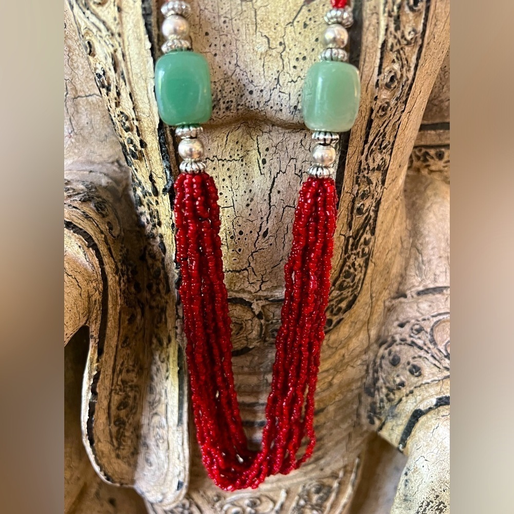 Costume jewelry  necklace with red beads and adventurine green stone beads.